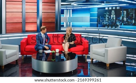 Talk Show TV Program and News Discussion: Two Cheerful Presenters Talk, Have Fun. Cable Channel Hosts Have Friendly Conversation. Mock-up Television Studio and Newsroom Entertainment Concept
