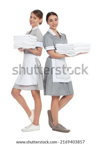Full length portrait of chambermaids with towels on white background Royalty-Free Stock Photo #2169403857