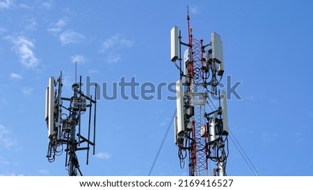 Telecommunication tower of 4G and 5G cellular. Macro Base Station. 5G radio network telecommunication equipment with radio modules and smart antennas mounted on a metal against cloulds sky background. Royalty-Free Stock Photo #2169416527