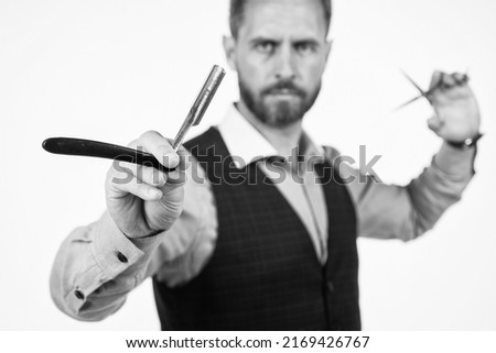 retro razor blade in hand of professional hairdresser, selective focus, hairdressing Royalty-Free Stock Photo #2169426767