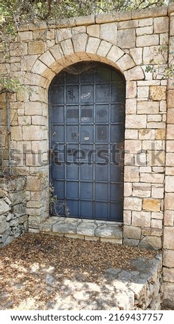 Old metal door in a stone wall