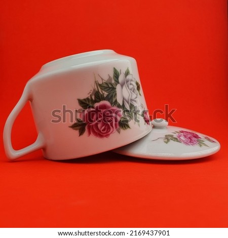 Vintage cup with flower picture with red background