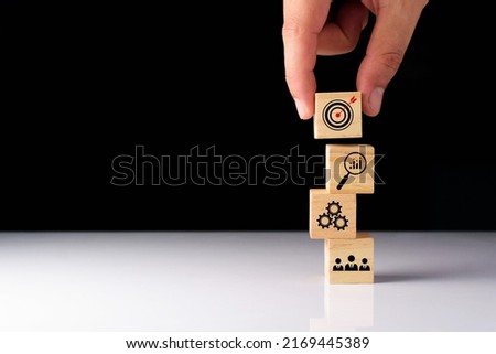 Business success goals Concept. Business man planning business operations. set business goals, use wooden blocks to plan, set goals for future success, use wooden blocks to create ideas, set target. Royalty-Free Stock Photo #2169445389