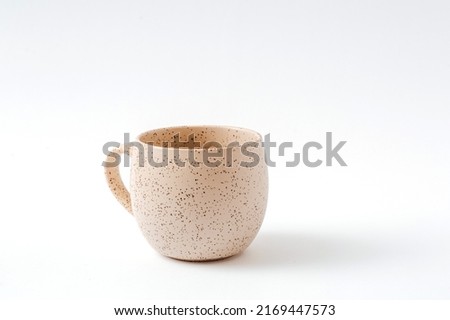 Empty beige coffee ceramic cup on isolated white background, cut out. Royalty-Free Stock Photo #2169447573