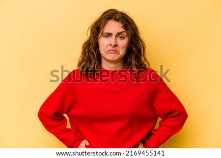 Young caucasian woman isolated on yellow background sad, serious face, feeling miserable and displeased. Royalty-Free Stock Photo #2169455141