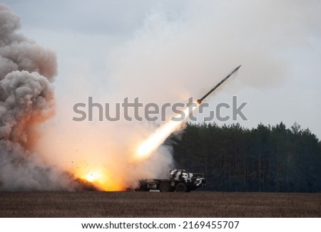 Launch of military missiles (rocket artillery) at the firing field during military exercise Royalty-Free Stock Photo #2169455707