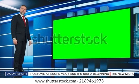 Talk Show TV Program: Handsome White Male Presenter Standing in Newsroom Studio, Uses Big Green Chroma Key Screen. News Achor, Presenter Talks About News, Weather. Mock-up of Cable Channel