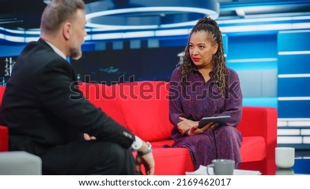 Talk Show TV Program, News Interview and Discussion: Presenter and Guest Talk. Cable Channel Hosts Have Friendly Conversation. Mock-up Television Studio and Newsroom Entertainment Concept