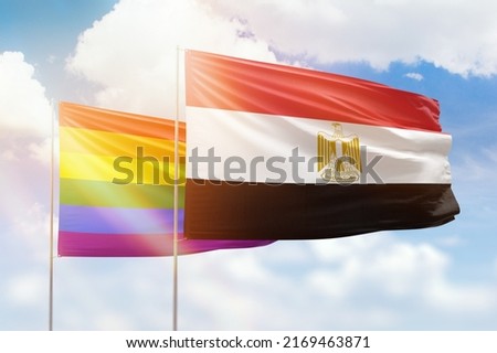 Sunny blue sky and flags of lgbt and egypt