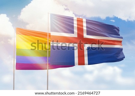 Sunny blue sky and flags of lgbt and iceland