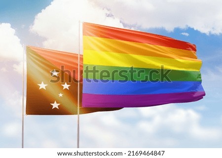 Sunny blue sky and flags of lgbt and papua new guinea