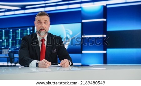 Beginning Evening News TV Program: Anchor Presenter Reporting on Business, Economy, Science, Politics. Television Cable Channel Anchorman Talks. Broadcast Network Newsroom Studio. Royalty-Free Stock Photo #2169480549