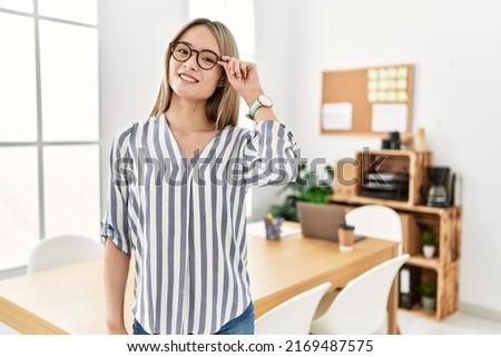 Young chinese woman smiling confident standing at office