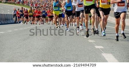 large group runners leading marathon race Royalty-Free Stock Photo #2169494709