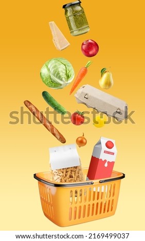 Yellow shopping basket with fresh food full of variety of grocery products, food and drink on yellow background. Supermarket food concept. Home delivery. Food ingredient float. Flying concept. Royalty-Free Stock Photo #2169499037