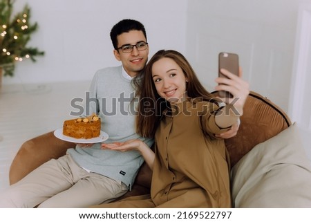 Young fun couple two woman man takind selfie with cake