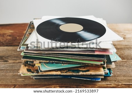 Stack of vinyl records. Listening to music from record. Playing music from analog disk. Retro and vintage. Audio stereo. Analog sound