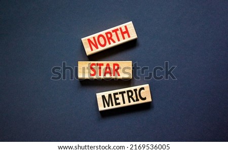 North star metric symbol. Concept words North star metric on wooden blocks on a beautiful black table black background. Business finacial and north star metric concept. Copy space.