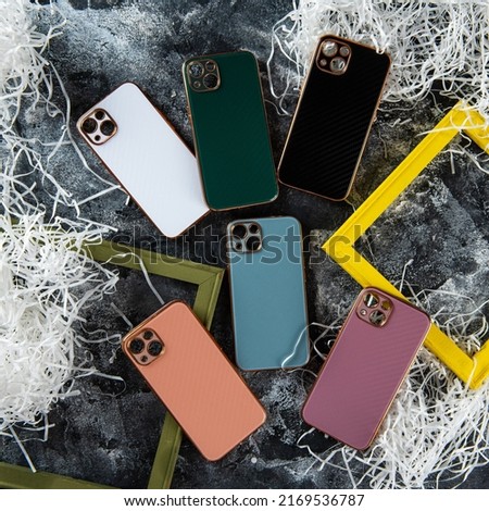 multi-colored cases for mobile phones on a gray background