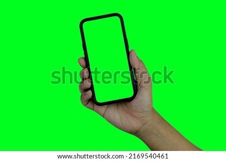Hand holding smartphone isolated on green background, The shape of a modern mobile smartphone Designed to have a thin edge. green screen background - Clipping Path.