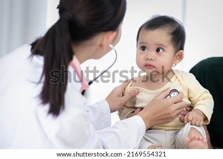 An Asian baby girl comes to see a female doctor for a check-up. Royalty-Free Stock Photo #2169554321