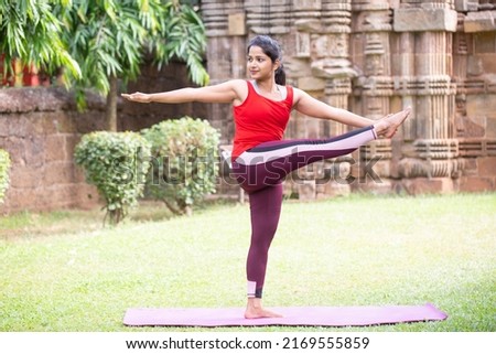 Asian Girl keep calm and meditates while practicing yoga to explore the Inner Peace.working out, outdoor close up. Well being, wellness concept