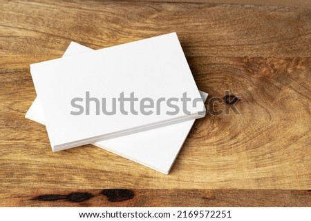 Two piles of blank business cards on table