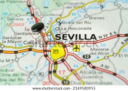 Tourist destination of Sevilla with a pin on a map, macro photo.