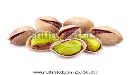 Salted Pistachio nuts in closeup isolated on white background.