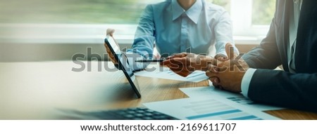 business consulting services. advisor and businessman working with digital tablet at desk in office. corporate strategy