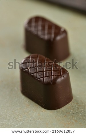 Brown chocolate on isolated background. Half chocolates include peanuts. Concept chocolate picture. Delicious chocolates. 