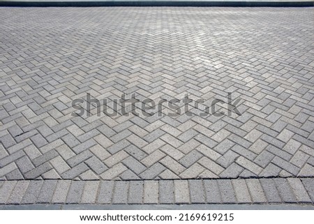 Textured chevron background pattern herringbone brick tile floor walkway or patio Royalty-Free Stock Photo #2169619215