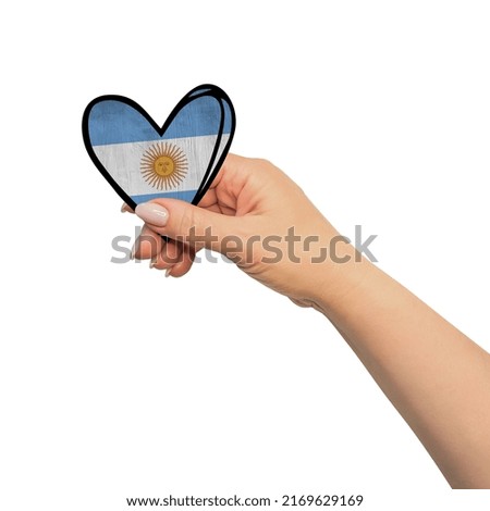 Woman hand is holding heart. Peace concept on white background. Argentina
