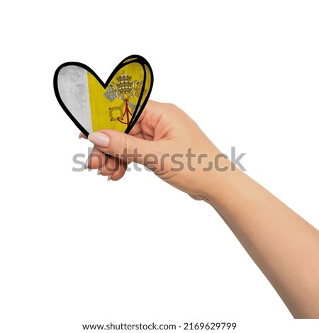 Woman hand is holding heart. Peace concept on white background. Vatican