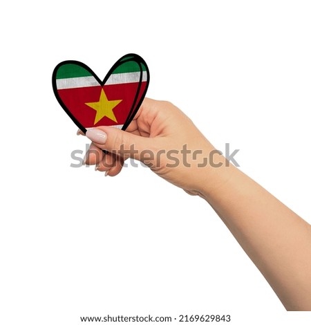 Woman hand is holding heart. Peace concept on white background. Suriname