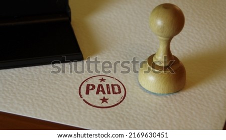 Paid stamp and stamping hand. Check, tax and money payment symbol concept.
