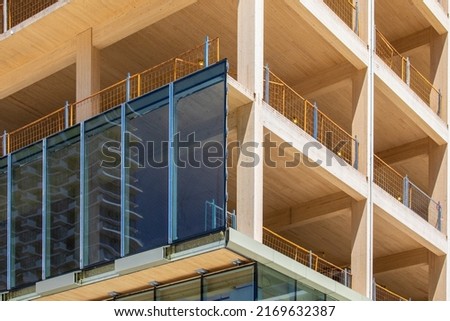 Glass curtain wall being installed on an engineered timber multi story green, sustainable, residential high rise apartment building construction project Royalty-Free Stock Photo #2169632387