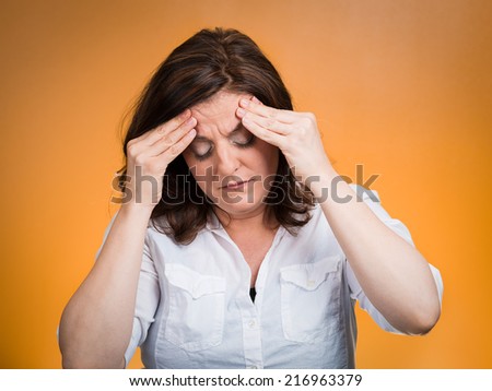 Stress headache. Closeup portrait stressed woman having many thoughts, worried about future, thinking isolated orange background. Human face expressions, feelings, emotions, life perception, reaction