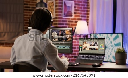 Graphic designer editing video montage on production software, working on computer to add visual effects and color gradient on footage. Edit creative multimedia film with sound. .