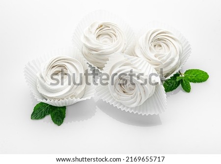 Small white meringues on a white background. meringue candy