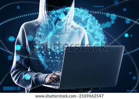 Hacker hand using laptop with bright globe hologram. A holographic projection of planet earth. Flickering energy particles on blurry abstract dark background. 