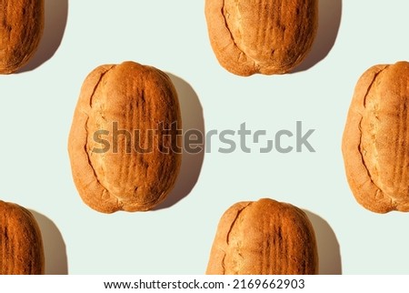 Composition from bread with shadows on blue pastel soft color background. Seamless pattern for wallpaper, background and textile. Eco-friendly products. Still life. Banner