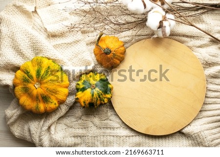 Autumn still life with pumpkins on the table, top view. Visual picture.