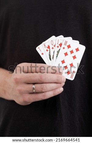 Male hands hold a deck of cards and show tricks.
The photographer is the author of the design of playing cards, which is written in the release of the property.