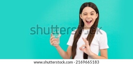 ok. kid hold glass of water. child feel thirsty. teen girl going to drink mineral beverage. Banner of child girl with glass of water, studio portrait with copy space. Royalty-Free Stock Photo #2169665183