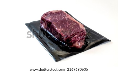 raw piece of beef for steak in vacuum packaging isolated on white background