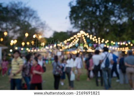Abstract blur people in night festival city park bokeh background - Retro filter effect. Outdoor festival and party or celebration concept. Royalty-Free Stock Photo #2169691821