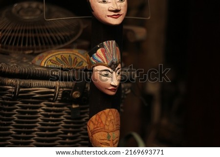 out of focus ancient masks sold as decoration