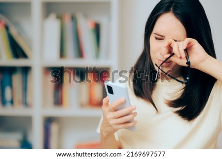 
Woman Checking Smartphone Rubbing her Dry Eyes. Girl suffering from digital eyestrain from overusing her phone
 Royalty-Free Stock Photo #2169697577
