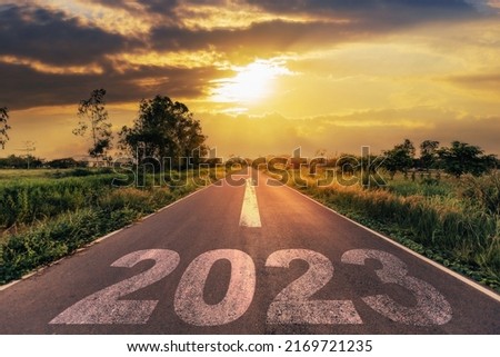 Empty asphalt road and New year 2023 concept. Driving on an empty road to Goals 2023 with sunset. Royalty-Free Stock Photo #2169721235